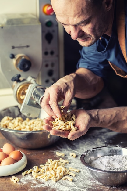 Freshly made twisted shape Italian pasta in the hands of a small producer.