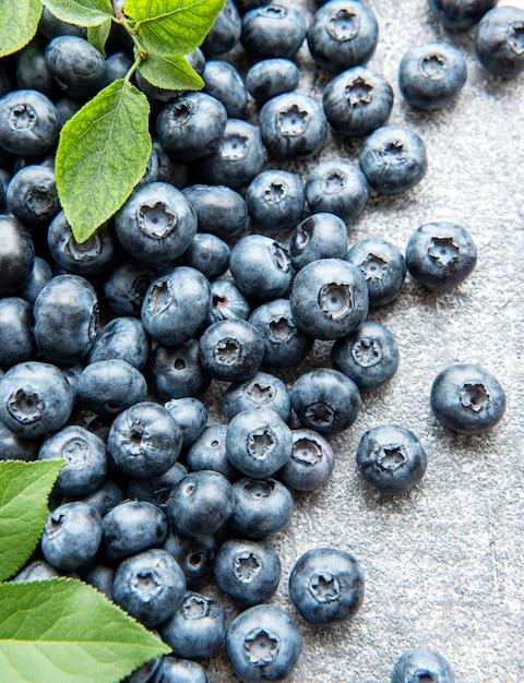 Freshly picked blueberries on a concrete background. Concept for healthy eating