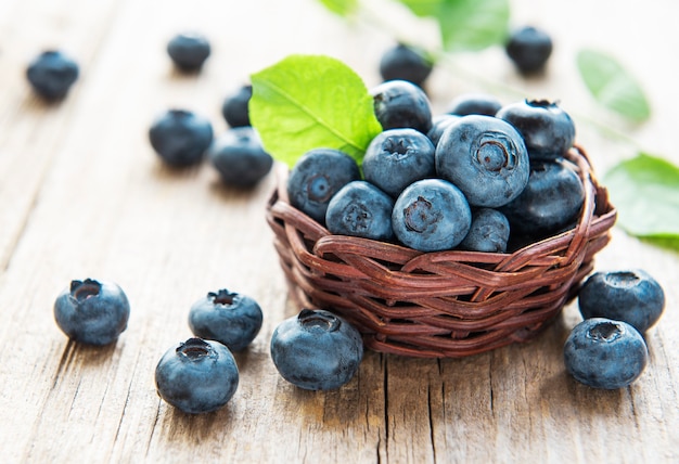 Freshly picked blueberries on a old wooden background. Concept for healthy eating