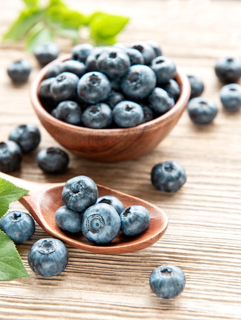 Freshly picked blueberries on a old wooden background. Concept for healthy eating