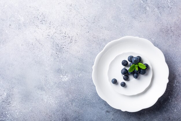 Freshly picked blueberries on white plate