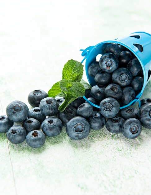 Freshly picked blueberries on a wooden background. Concept for healthy eating