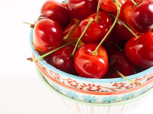 Freshly picked heap of cherries in bowl.