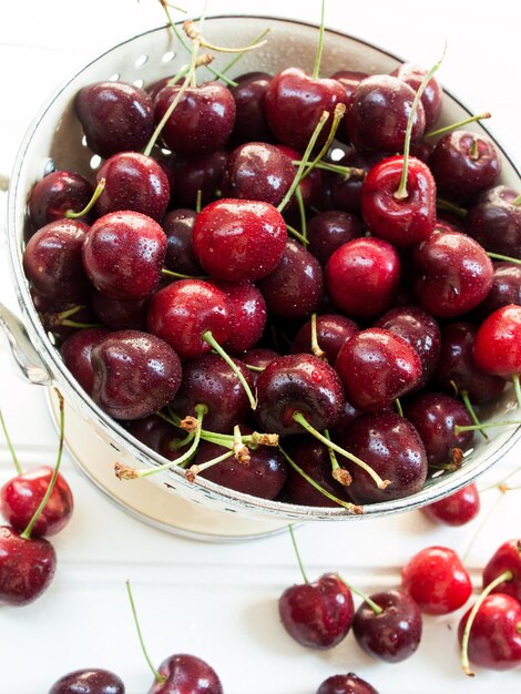 Freshly picked heap of cherries in colander.