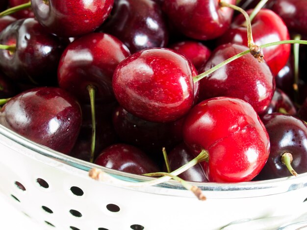 Freshly picked heap of cherries in colander.