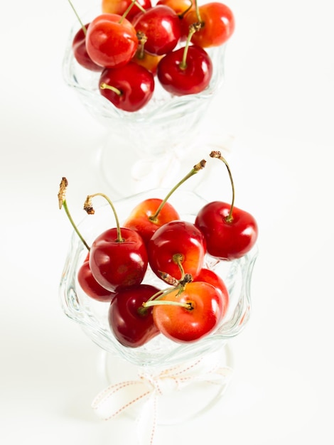 Freshly picked heap of cherries in glass dishes.