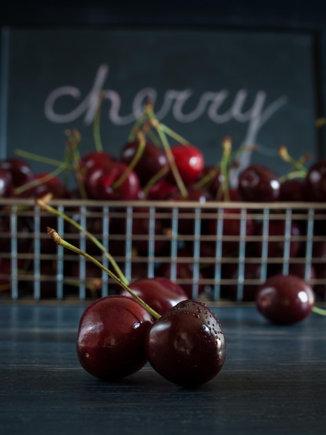 Freshly picked heap of cherries in metal basket.