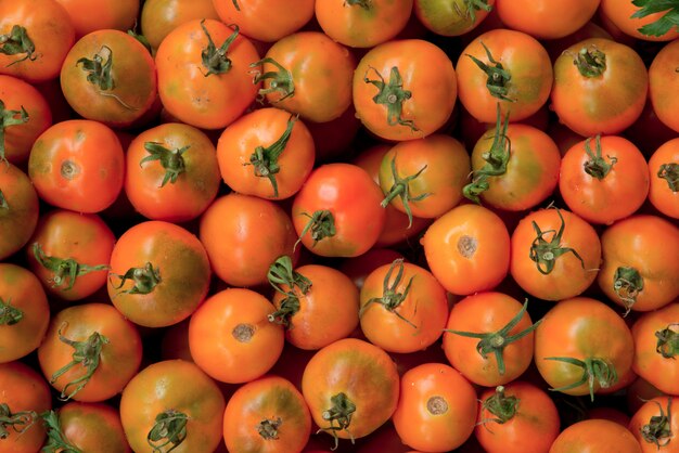 Freshly picked orange tomatoes at the farmers market