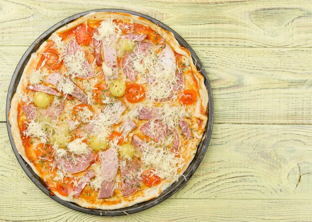 Freshly prepared homemade pizza on a baking dish