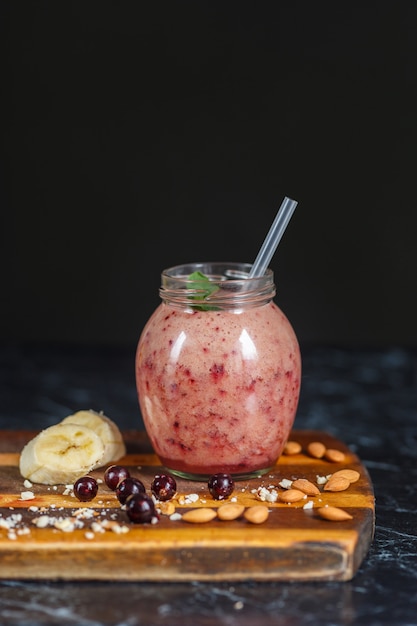 Freshly prepared smoothies from banana and blackberry in bottle. Diet, healthy lifestyle