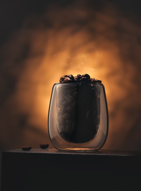 Freshly roasted coffee beans in a glass cup