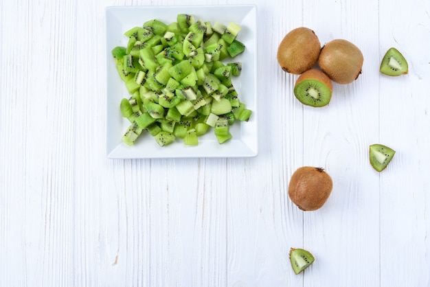 Freshly sliced kiwi fruit with whole kiwis