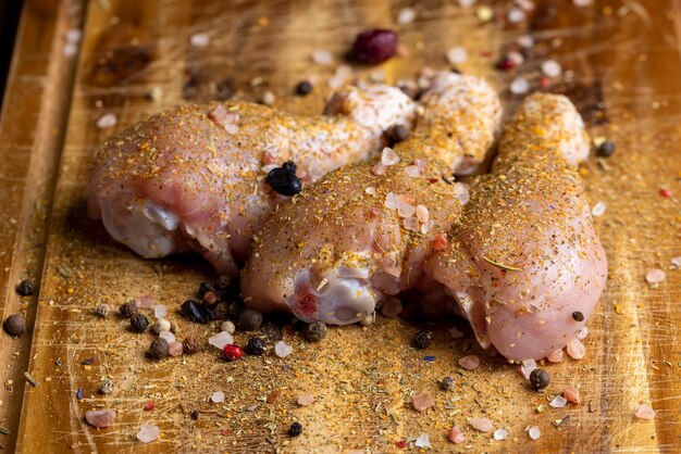 写真 洗いたての皮を剥いた鶏肉の鶏もも肉に塩とスパイスを加えて調理する準備ができています