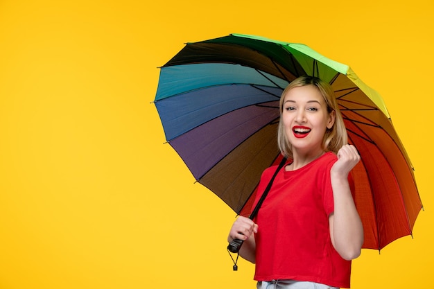 Frevo cute blonde girl celebrating brazilian festival holding fists of excitement with umbrella