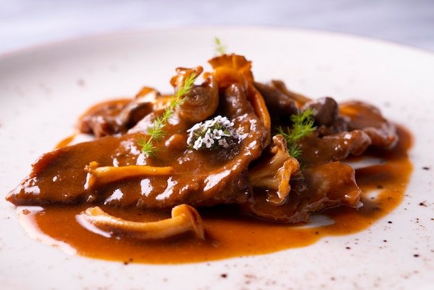 Fricando veal cooked with sauce, vegetables and mushrooms. typical spanish tapa recipe