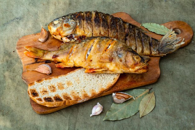 Fried appetizing fish on barbecue picnic food closeup