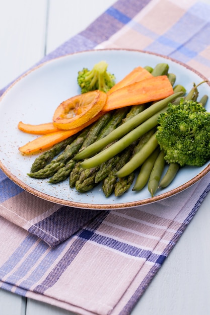 Fried asparagus with broccoli and lemon and carrot