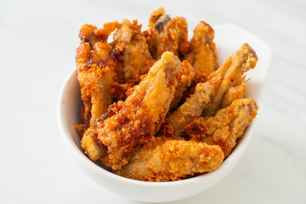 fried barbecue chicken wings in white bowl