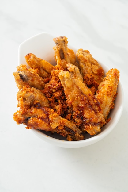 fried barbecue chicken wings in white bowl