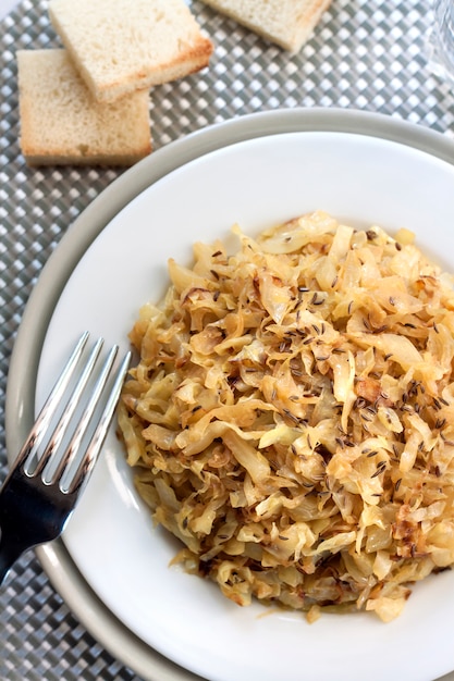 Fried cabbage with caraway and garlic on a plate