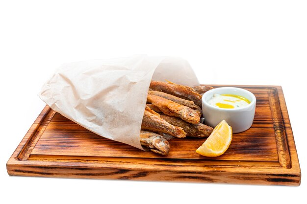 Fried capelin is served on a plank