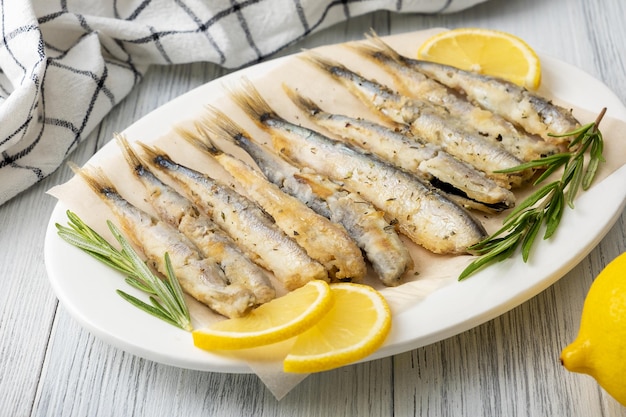 Fried capelin on a white porcelain dish