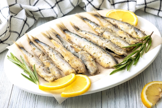 Fried capelin on a white porcelain dish