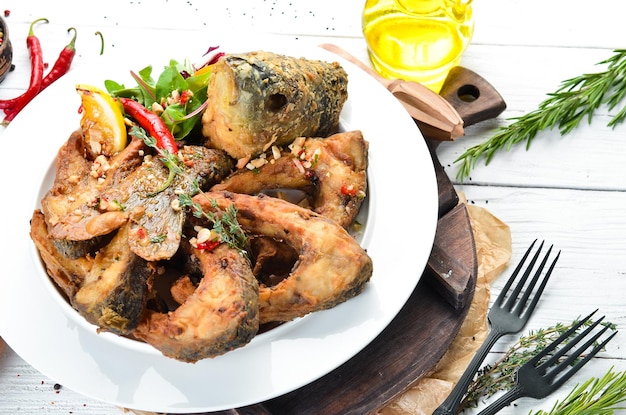 Fried carp fish in oil Restaurant dishes Top view Free copy space