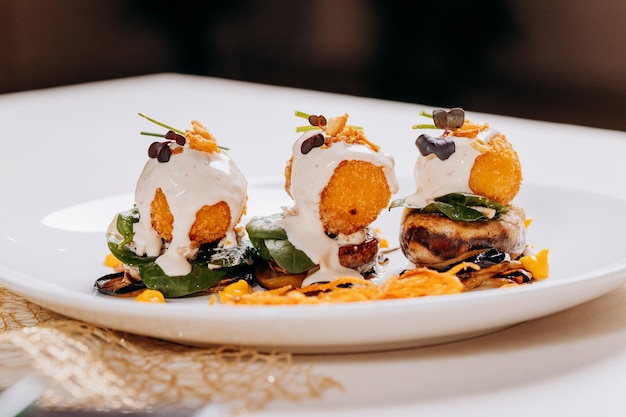 Fried cheese balls are served on a pillow of mushrooms and eggplant ready for eat Restaurant menu