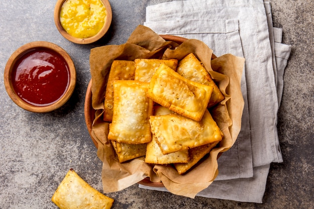 Fried cheese empanadas with sauces