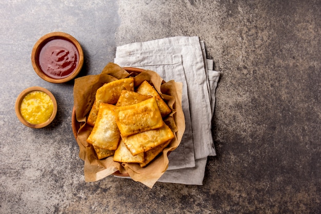 Fried cheese empanadas with sauces