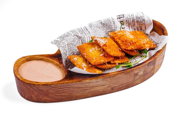 Fried cheese empanadas on wooden board