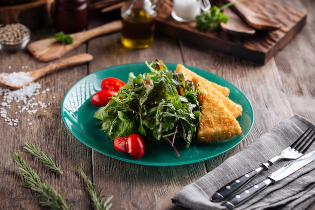 Fried cheese with green and tomatoes salad