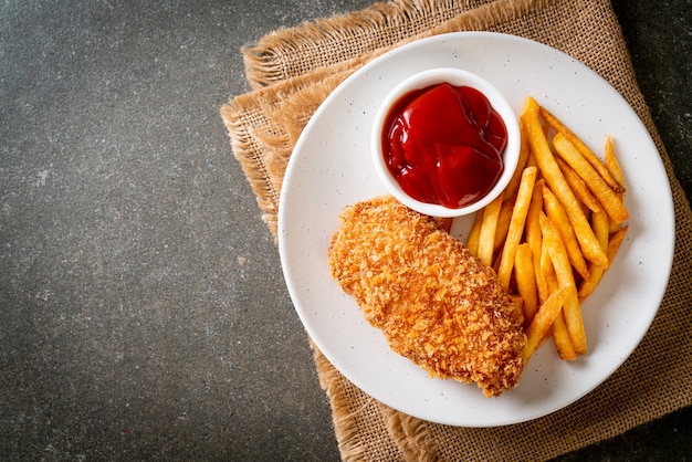 fried chicken breast fillet steak with French fries and ketchup