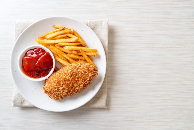 fried chicken breast fillet steak with French fries and ketchup