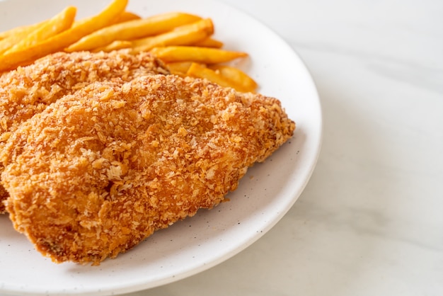 fried chicken breast fillet steak with French fries and ketchup