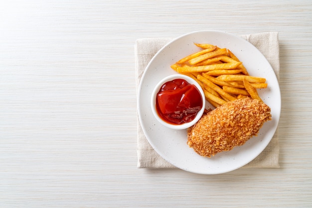 fried chicken breast fillet steak with French fries and ketchup