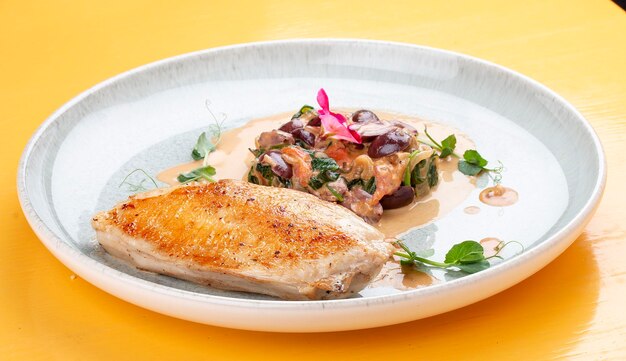 Fried chicken breast with stewed spinach and grapes