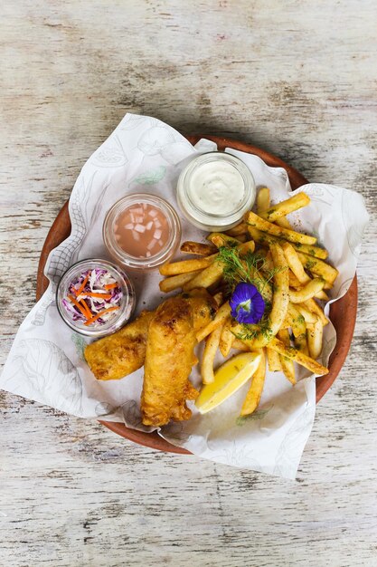 Fried Chicken Dinner with chips mayo dip and chilli sauce served in a dish isolated on background top view of fastfood