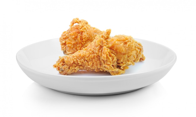 Fried chicken drumsticks in plate isolated