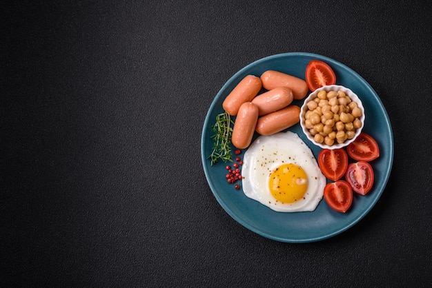 Fried chicken eggs sausages cherry tomatoes chickpeas spices salt and herbs