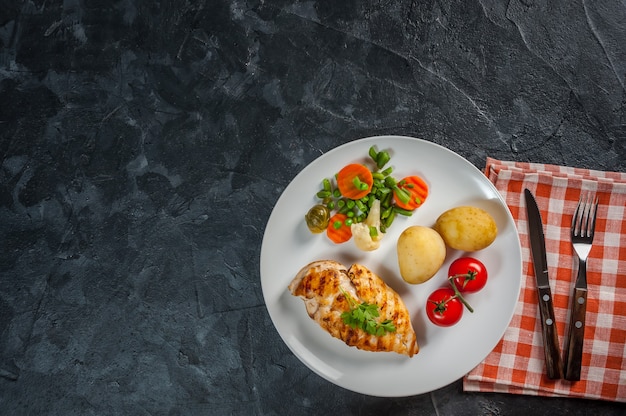 Fried chicken fillet and boiled vegetables, delicious barbecue dinner