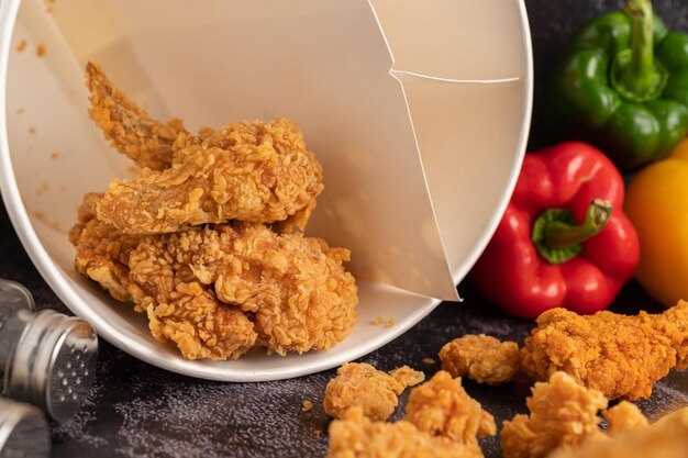 Fried Chicken and French Fries on Black Cement Floor