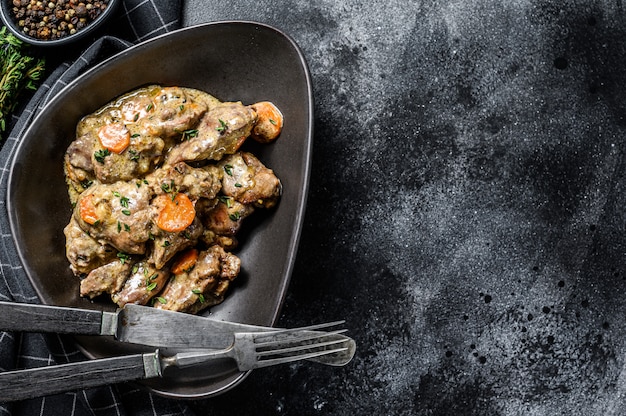 Fried chicken liver with onions and herbs . 