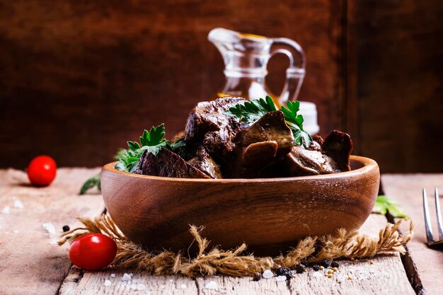 Fried chicken livers in a bowl vintage wooden background selective focus