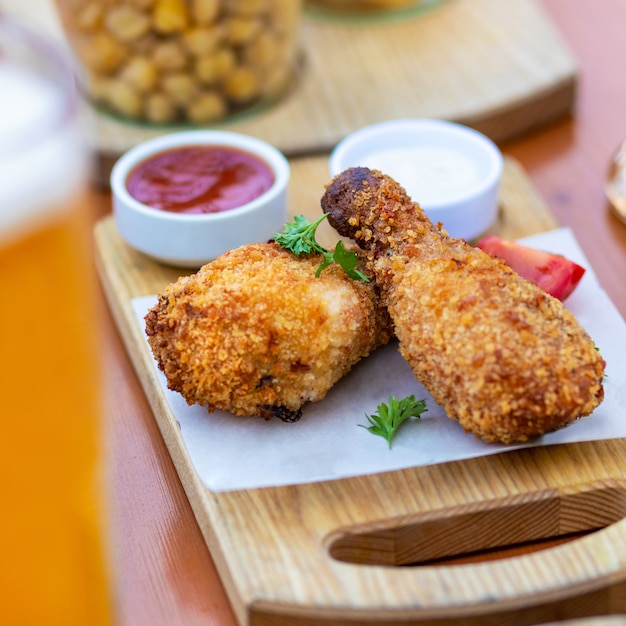 Fried chicken meal with beer and sauce