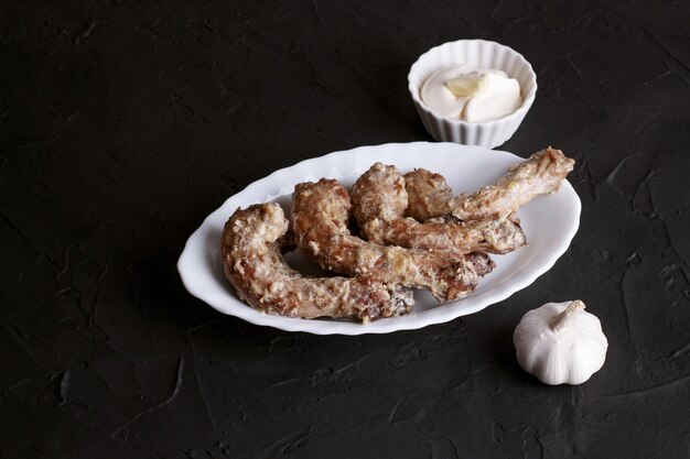 Fried chicken necks in sour cream garlic sauce