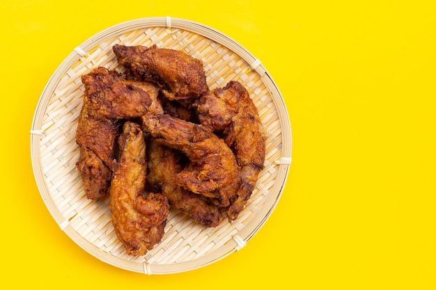 Fried chicken necks on yellow background