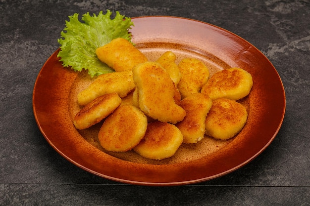 Fried chicken nuggets served salad leaves