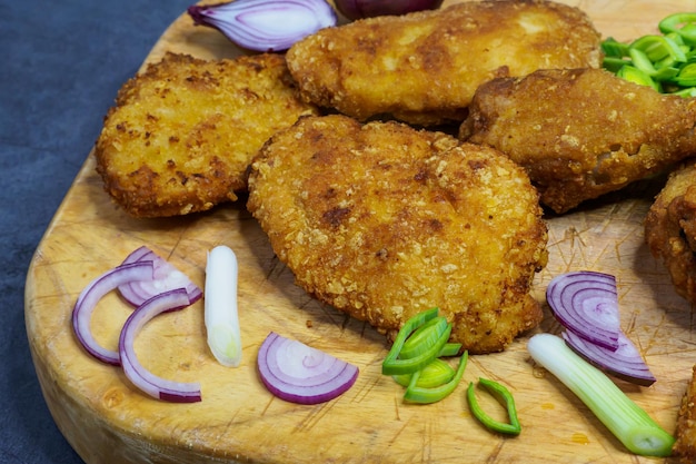 Fried chicken schnitzel on a cutting board Homemade breaded schnitzel Fried crispy chicken legs